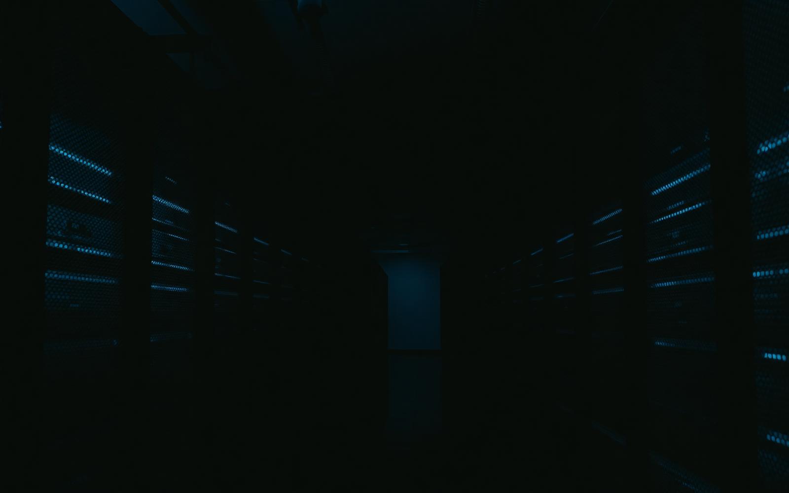 Dark data center hallway with blue rack lights